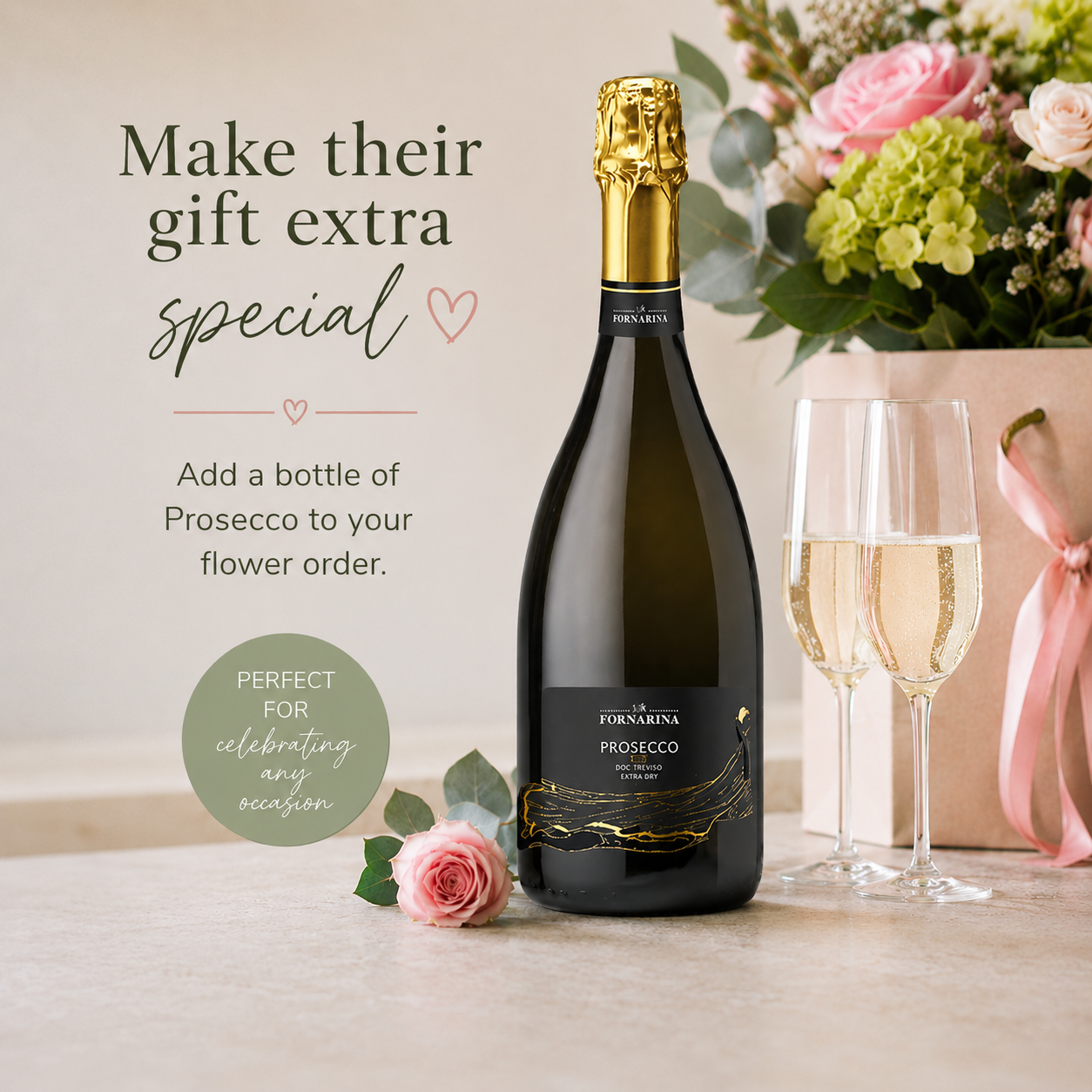 a bottle of presecco with pink roses and two glasses