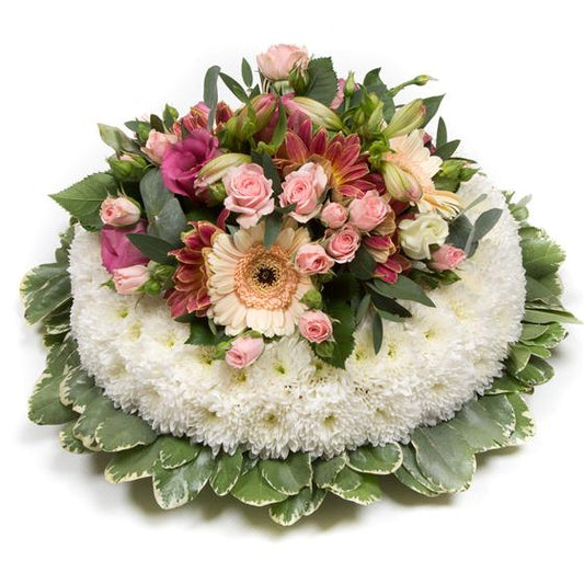 Floral arrangement with white base, pink and orange flowers, and green leaves on a white background