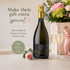 a bottle of presecco with pink roses and two glasses 