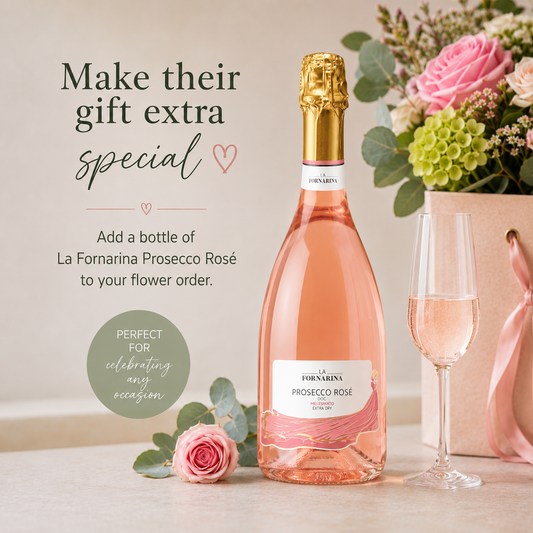 Bottle of rose Prosecco with roses and a glass 